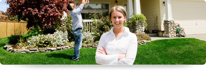 happy family with kids in front of house